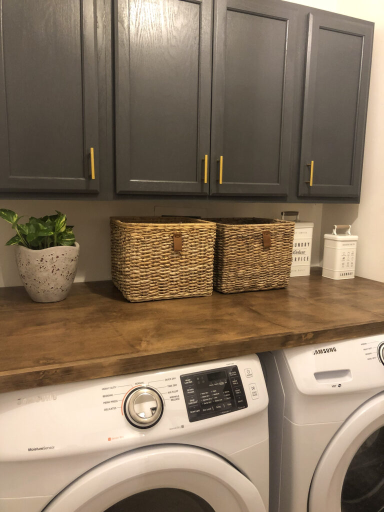 new laundry room stained countertop with added cabinet storage modern farmhouse laundry room 

