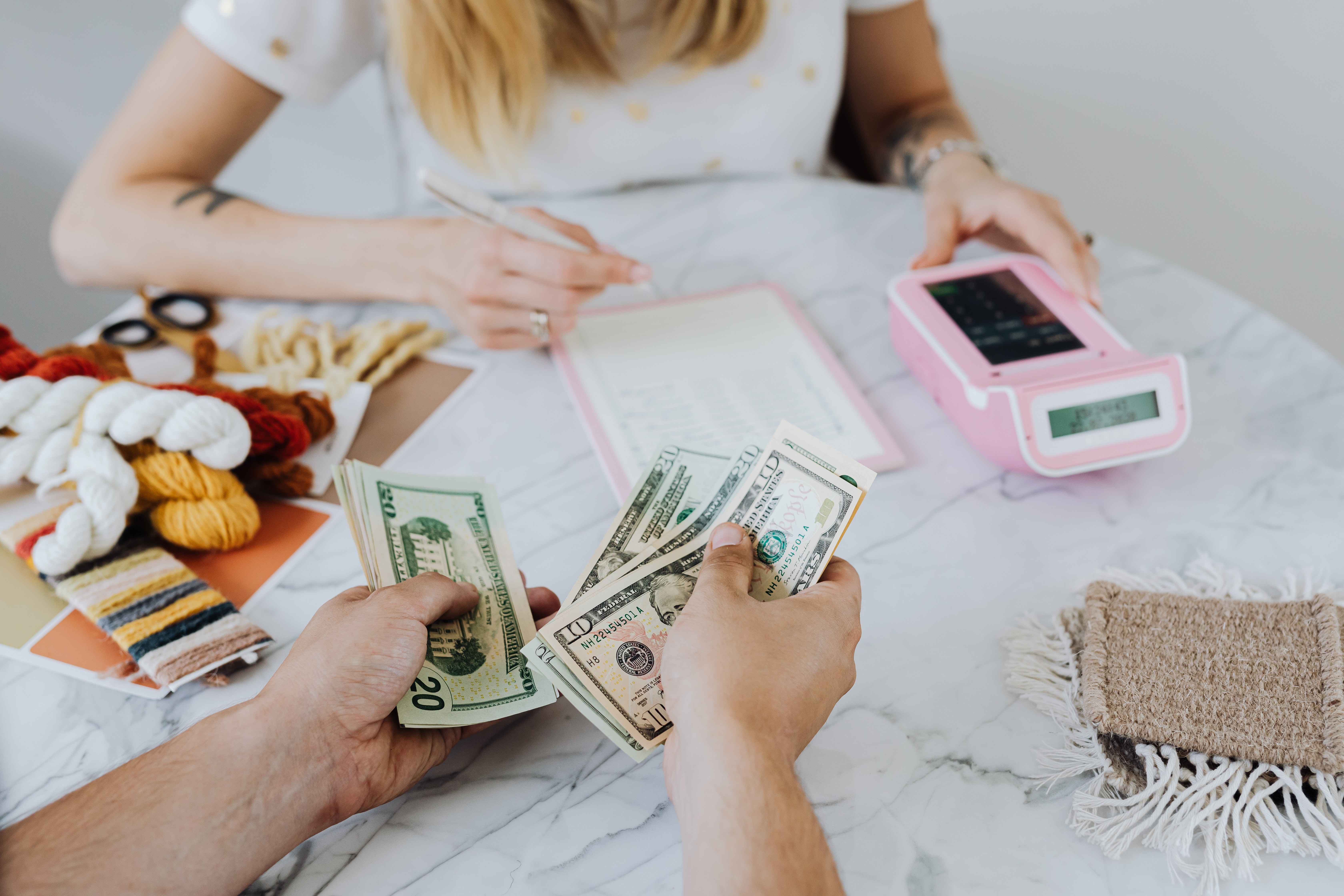 Customer paying someone who is keeping track of their income